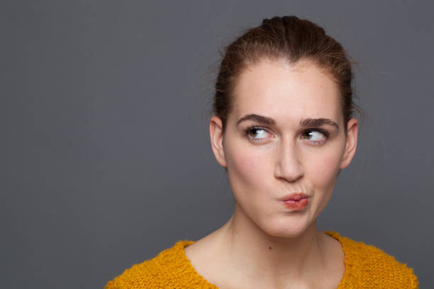 istock concerned beautiful girl thinking, expressing emotions of doubt, studio shot 1178808981