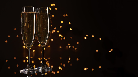 Two glasses of champagne on a dark background with LED lights garland. Copy space for text.