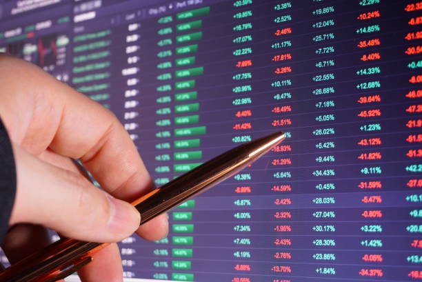 istock Trader 's hand point pen on price chart trading screen. 1178810725