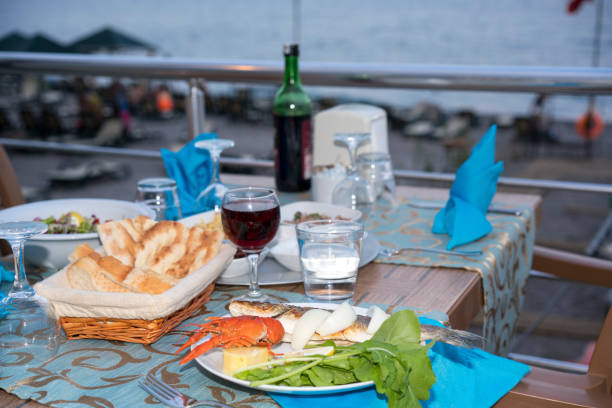 istock table at the beach with fish and wine 1178811479