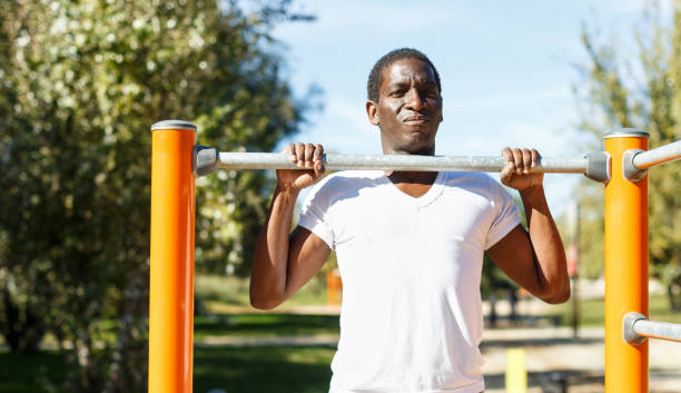 istock Active african  american man doing workout at pull-up bar  in park 1178815334