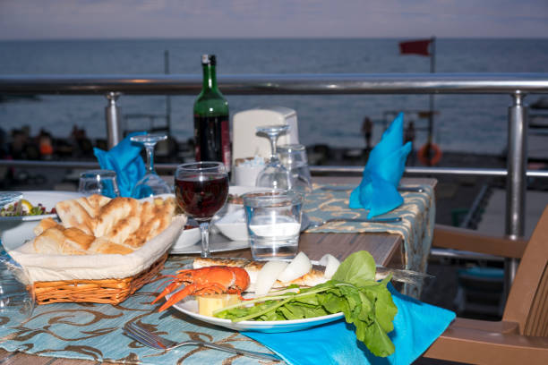 istock table at the beach with fish and wine 1178815415
