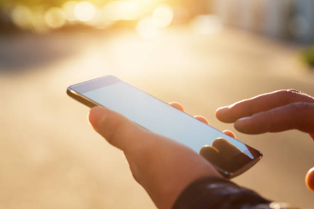 istock Man holding smart phone with blurred background. 1178817156