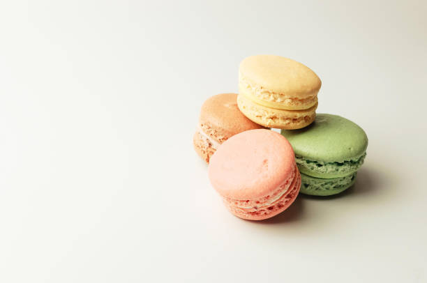 istock fresh colored macaroons lie in a heap aside. Meringue on an isolated background with copy space 1178817161