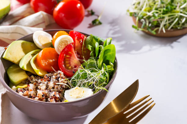 istock Fresh healthy salad with quinoa, cherry tomatoes and mixed greens, avocado, egg and micro greens on marble background top view. Food and health. Superfood meal. Clean eating. Healthy lifestyle 1178817835