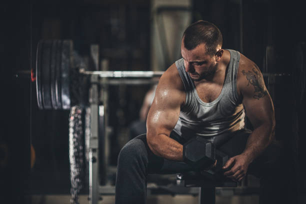 istock Muscular man doing exercises with dumbbells 1178819134