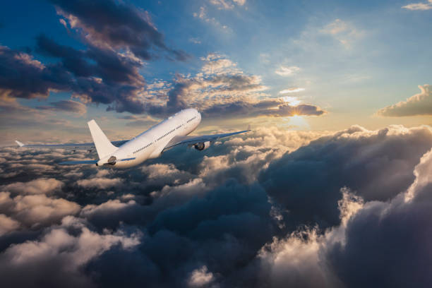 istock Passenger airplane flying above clouds during sunset 1178821920