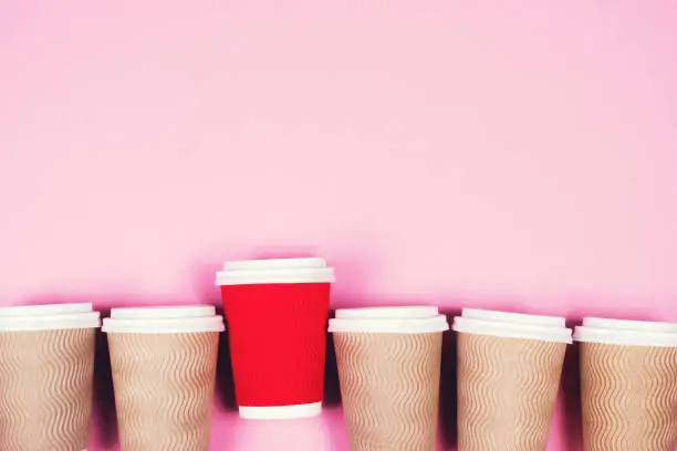 Photo of Paper cups on pink background