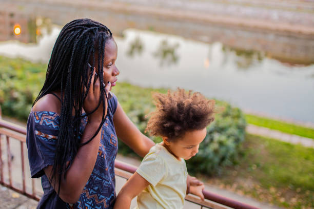 istock African American woman with child using phone 1178823638