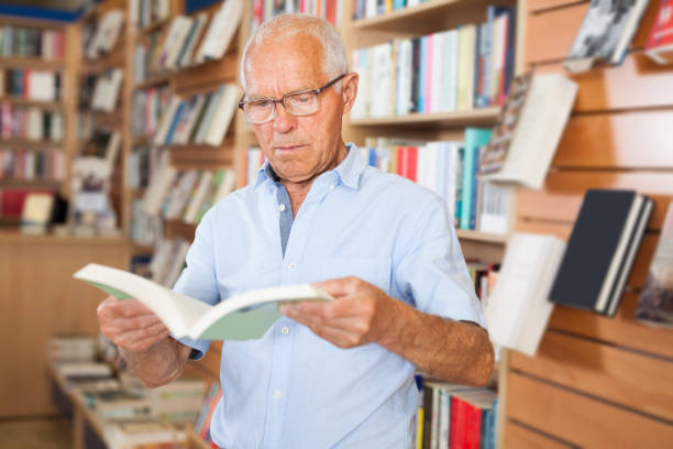 istock Older man customer browsing inside of books in  bookshop 1178826923