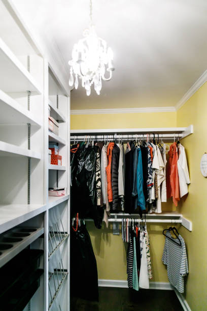 istock large yellow master bedroom closet with white wood shelves 1178826953