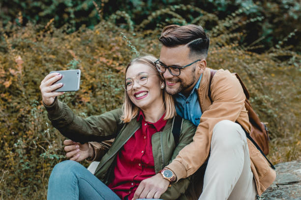 istock Young couple taking selfie in public park 1178827350