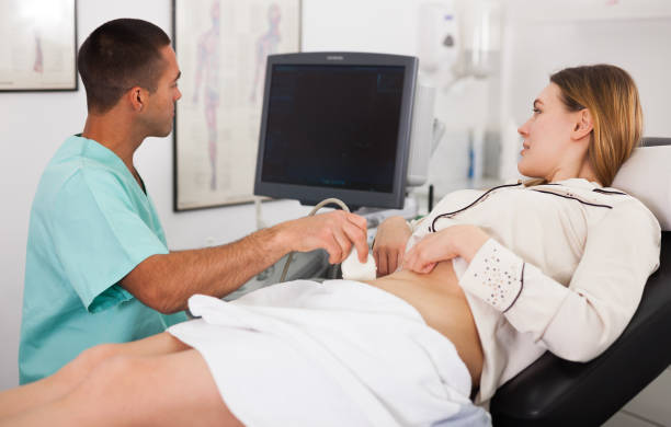 istock Man sonographer examining female patient 1178828588