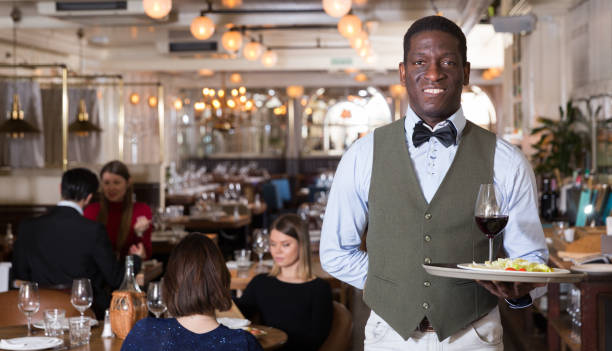 istock Man waiter is standing with order in hall 1178829964