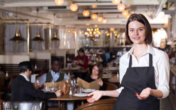 istock Woman waiter is welcoming clients 1178830102