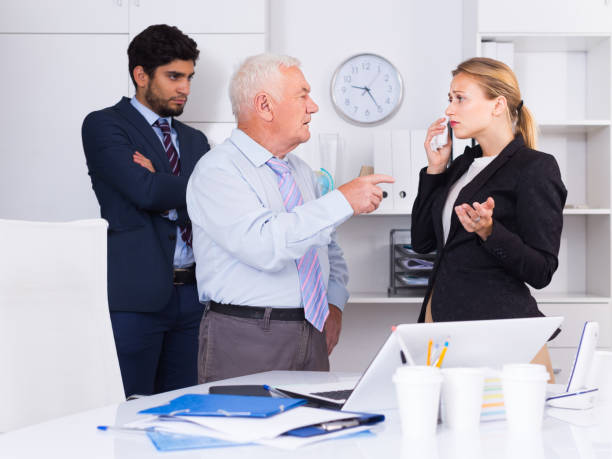 Mature boss is chastising employees because of uncompleted work Mature boss is chastising employees because of uncompleted work in the office. uncompleted stock pictures, royalty-free photos & images