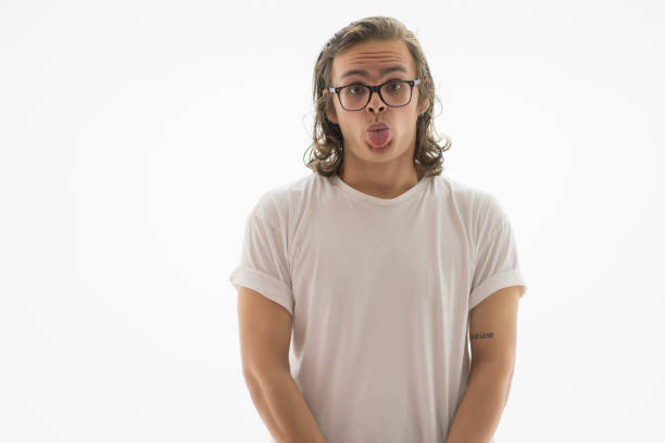 Young handsome blond man sticking tongue out happy with funny expression