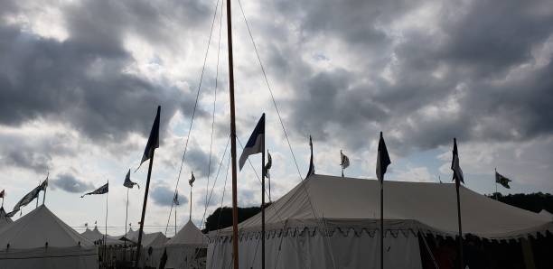 Silhouette of tents against a cloudy sky