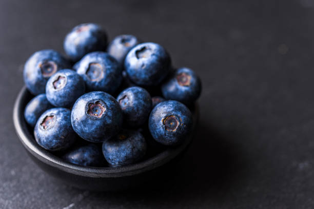 istock Close up of fresh organic blueberries on black background 1178836716