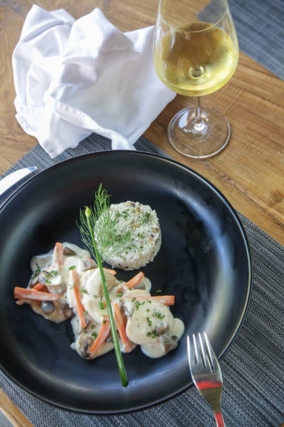 istock Poached chicken roll with white wine sauce served with mushroom pilaf rice. Exquisite dish. Creative restaurant meal concept. Haute couture food on black. Fine dining concept. 1178840599