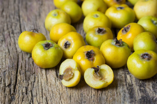 Fresh ripe yellow hawthorn fruits on wooden rustic background. Crataegus monogyna berries, healthy food for heart stock photo