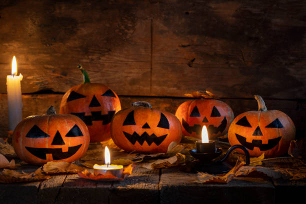 istock Halloween pumpkins head jack o lantern on wooden table background 1178849449