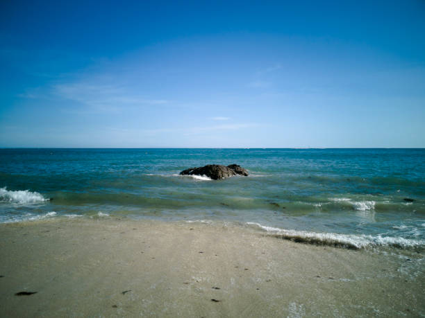 Lone rock on a sunny beach