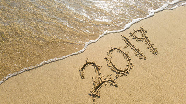 istock wave erases 2019 text on the beach 1178851507