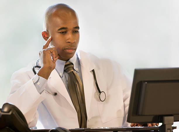 istock African-American Doctor Looking at Computer 117885676