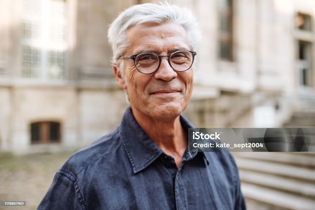 Street portrait of smiling  senior man Portrait of senior man Senior Adult Stock Photo