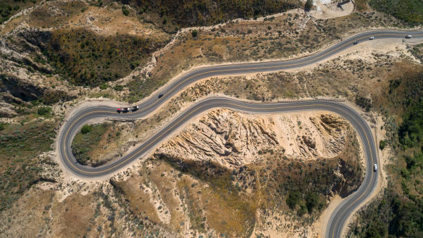 directly above aeriall view of the twisty mountain highway grimes canyon road nearby moorpark, california. - twisty road imagens e fotografias de stock