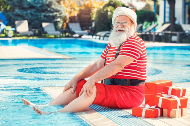 Santa Claus near the pool holiday vacation concept stock photo