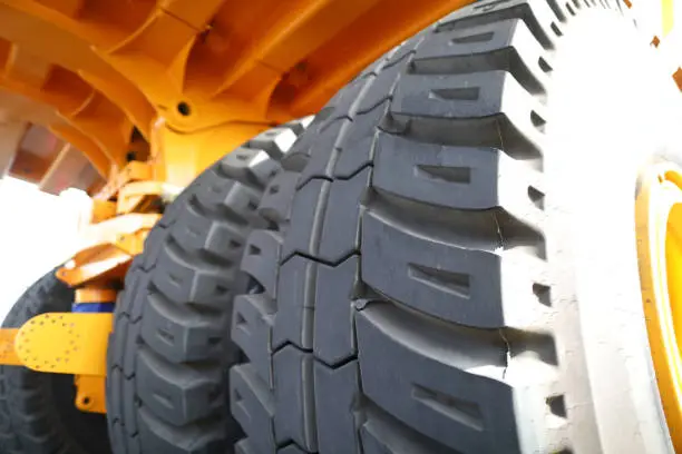 Huge rear wheels of dump truck at unusual angle closeup