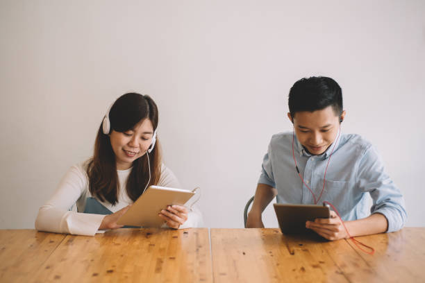 istock two asian chinese playing online game using digital tablet at the cafe 1178865058