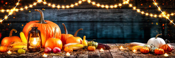 istock Wooden Table With Lantern And Candles Decorated With Pumpkins 1178869101