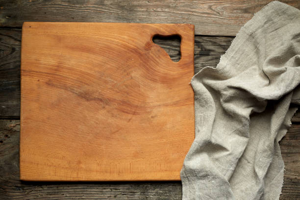istock empty square wooden kitchen cutting board and gray linen towel 1178869818