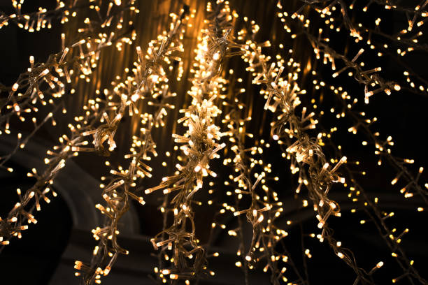 istock Gold sparkle from night light bulb hanging on ceiling  for celebration Christmas and new year background 1178871104