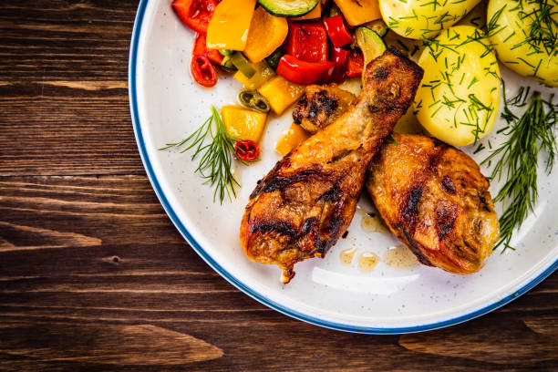 istock Roast chicken legs with fried potatoes and vegetables 1178888014