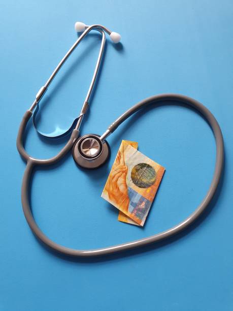 stethoscope for medical check and swiss money - swiss coin swiss currency currency switzerland imagens e fotografias de stock
