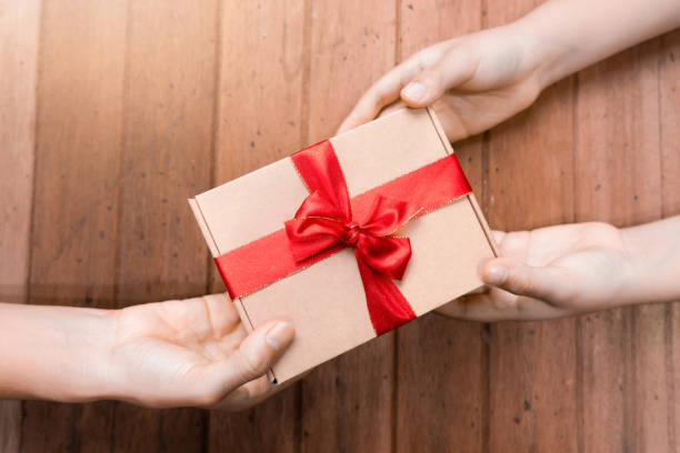 istock Hands hold gifts on New Year Day 1178888306