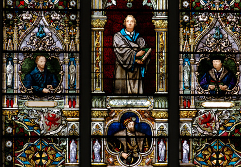 Part of a stained glass window in St Mary’s Church, Kersey, in Suffolk, Eastern England, which bears the Biblical phrase “Suffer little children to come unto me” (Matthew Chapter 19 verse 14).