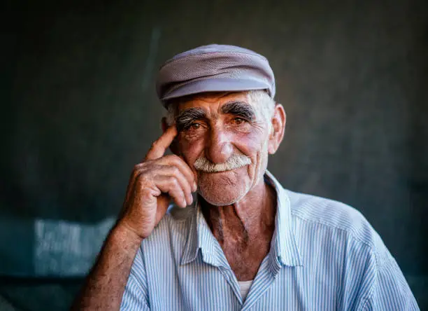 Close up portrait of a senior man over dark background, Erzincan, Turkey