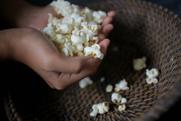 istock Closeup of hand with popcorn 1178891368