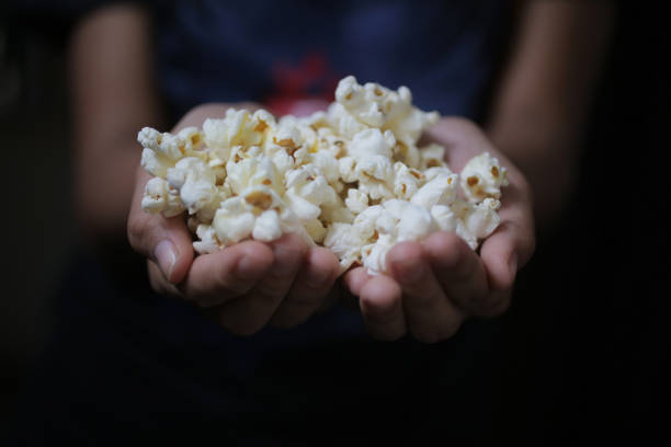 istock Closeup of popcorn in hand. 1178891398