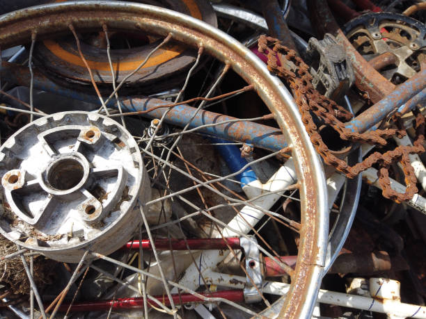 Pile of abanoned bicycle parts in a junk yard, outdoor close-up