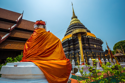 Ancient Buddha statue wearing a cerimonial robe at Yai Chai Mongkhon temple. Ayutthaya. Phra Nakhon Si Ayutthaya province. Thailand.