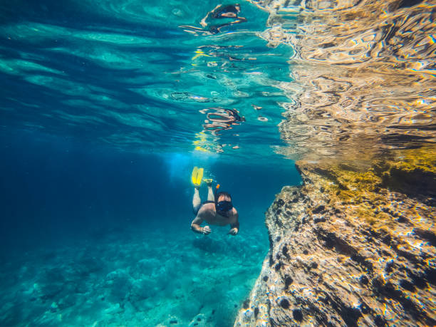 istock Men snorkeling by the reef 1178898954