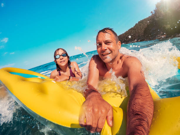 istock Father and daughter having fun on the beach 1178901466