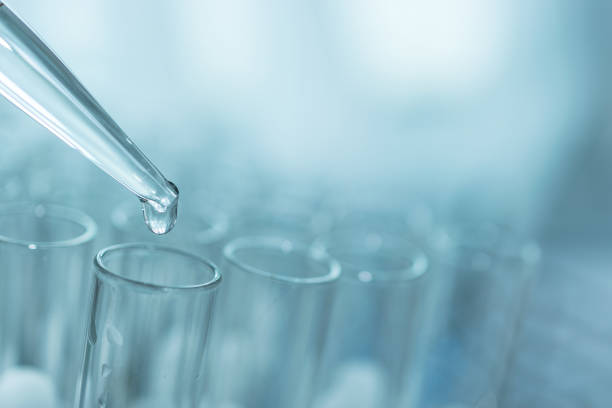 istock dropping liquid to test tubes, science laboratory research and development concept 1178901711