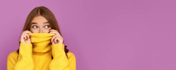 istock Girl pulling her trendy sweater over head having fun 1178902803